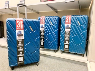 three blue hardside spinner luggage american tourister set on shelf