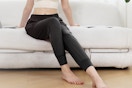 woman posing with joggers on the couch