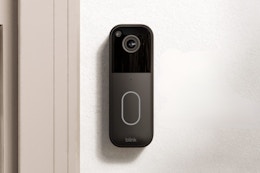 black Blink doorbell next to door frame