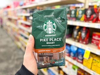 hand holding starbucks pike place ground coffee