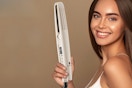 Woman holding a Hair straightener.