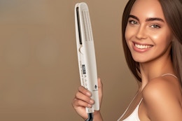 Woman holding a Hair straightener.