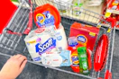 scott toilet paper, huggies wipes, tide detergent, garnier shampoo, colgate toothpaste, and total home trash bags in a cart