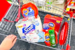 scott toilet paper, huggies wipes, tide detergent, garnier shampoo, colgate toothpaste, and total home trash bags in a cart