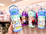 hand holding a bluey thermos water bottle in front of target shelf