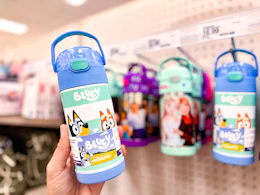 hand holding a bluey thermos water bottle in front of target shelf
