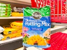 bag of miracle gro potting mix sitting on a target cart