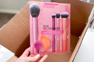 hand holding a real techniques makeup brush set