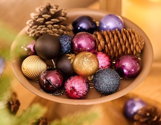 Christmas ornaments in a bowl with decorations