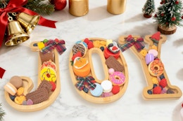 Nsoyos JOY 3PCS Bamboo Christmas Decorations Letters Charcuterie Board on a kitchen counter.