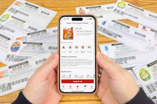 someone looking at digital and paper P&G coupons