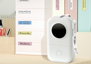 a label maker in front of an organizer with labels