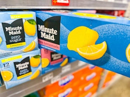 a 12 pack of Minute Maid Lemonade being pulled from shelf