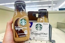 person holding a starbucks frappuccino drink in front of a shelf