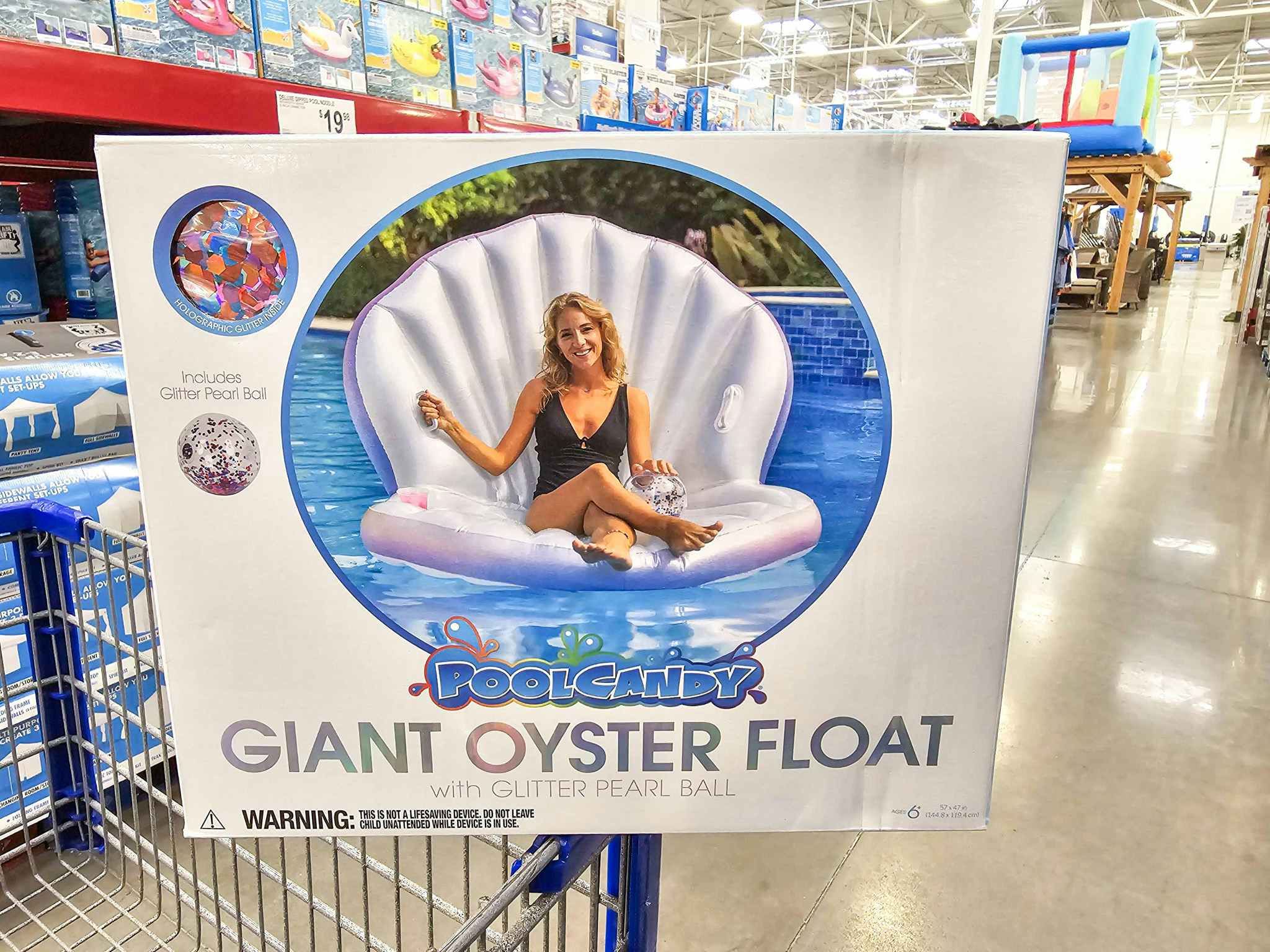 giant oyster pool float on the edge of a cart in an aisle