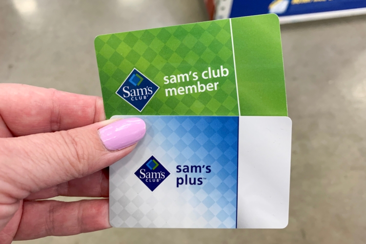 Two sams club membership cards held up in store