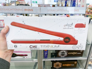 Woman holding box of Ulta Beauty CHI flat iron.
