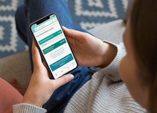 AmazonSmile is ending because donations haven't been large, Amazon says. This woman looks at a screen with lifetime donation totals.