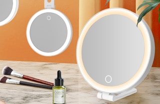 a lighted travel mirror on a counter