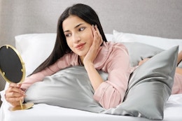 Woman laying on satin pillowcase.