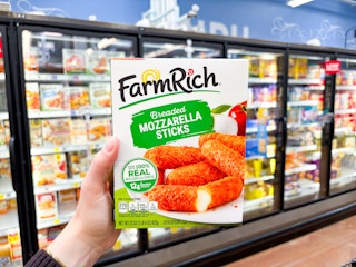 hand holding a box of farm rich appetizers