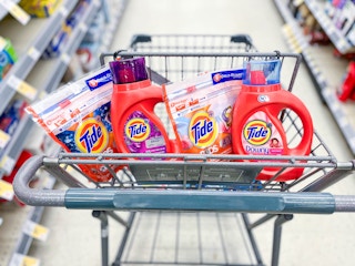 two Tide Pods and two Tide liquid laundry detergent inside shopping cart
