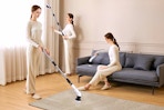 Lifestyle image of a woman using an electric spin brush in 3 different ways to clean her house