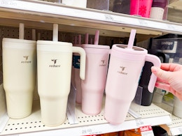 hand grabbing a 40-ounce reduce tumbler off a target shelf