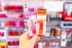 person holding 2 maybelline baby lips lip balms
