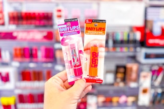 person holding 2 maybelline baby lips lip balms