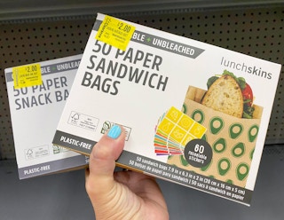 hand holding two lunchskins paper bags at walmart
