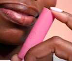 a person holding a lip balm tube 