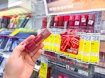 hand holding maybelline teddy tint lipstick in cvs