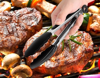 a hand holding a pair of cooking tongs