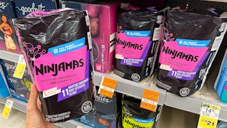 hand holding a bag of ninjamas diapers on clearance at walgreens