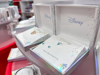 A Disney Necklace sitting on a display with other Disney necklaces.