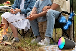 a bluetooth speaker by a campfire
