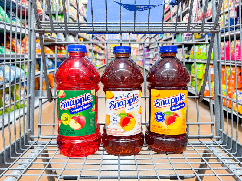 3 snapple juice bottles sitting in a walmart cart