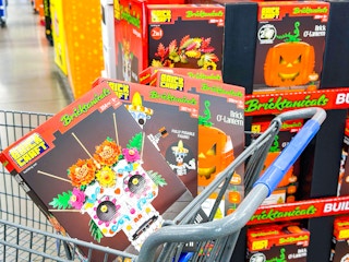 3 Brickcraft Botanicals Sets in Walmart shopping cart in front of center aisle display