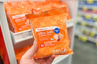 hand holding a pack of CVS Health baby wipes