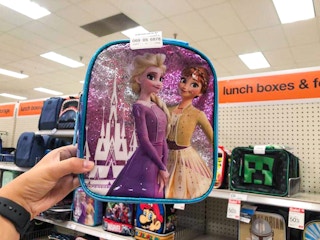 hand holding a disney frozen lunch tote at target