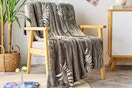 Lifestyle image of a KBL throw blanket draped over a chair