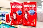 2 packages of huggies diapers on a shelf