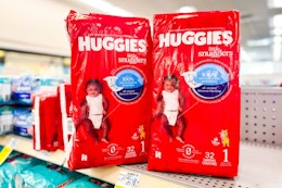 2 packages of huggies diapers on a shelf