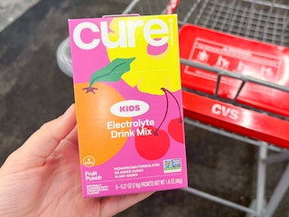 hand holding a box of cure hydration kids electrolyte drink mix