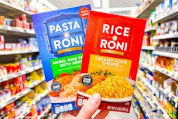hand holdling rice-a-roni and pasta-roni boxes