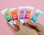 a hand holding small colorful tubes of Lume deodorant