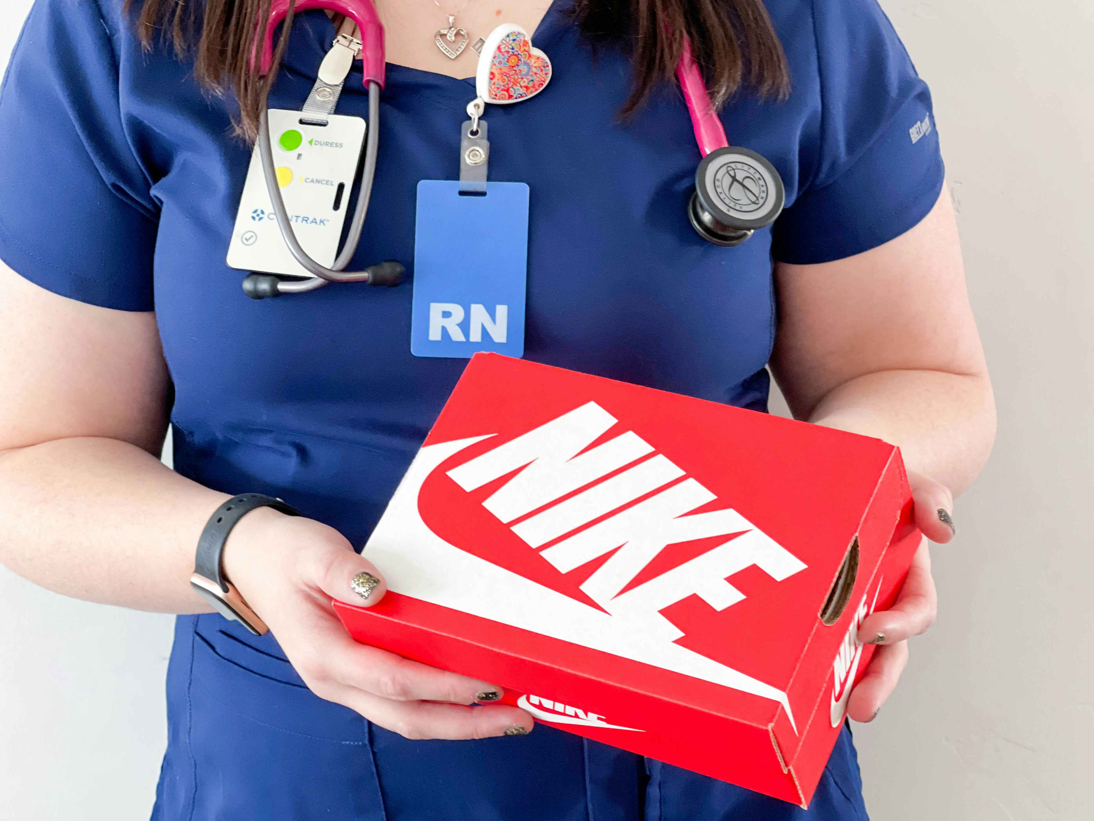 a nurse holding a nike box