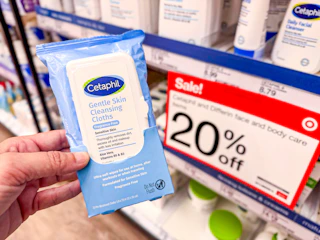 hand holding a pack of cetaphil wipes in front of target signage