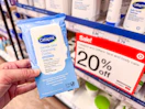 hand holding a pack of cetaphil wipes in front of target signage